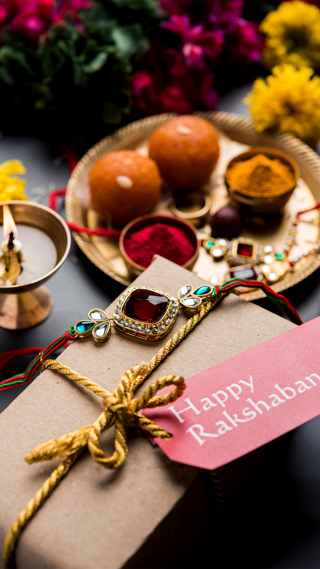 Beautiful Raksha Bandhan gift box with decorative rakhi, traditional sweets, roli chawal, and festive thali celebrating sibling bond